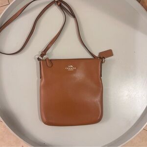 Coach North/South crossbody bag in brown leather.